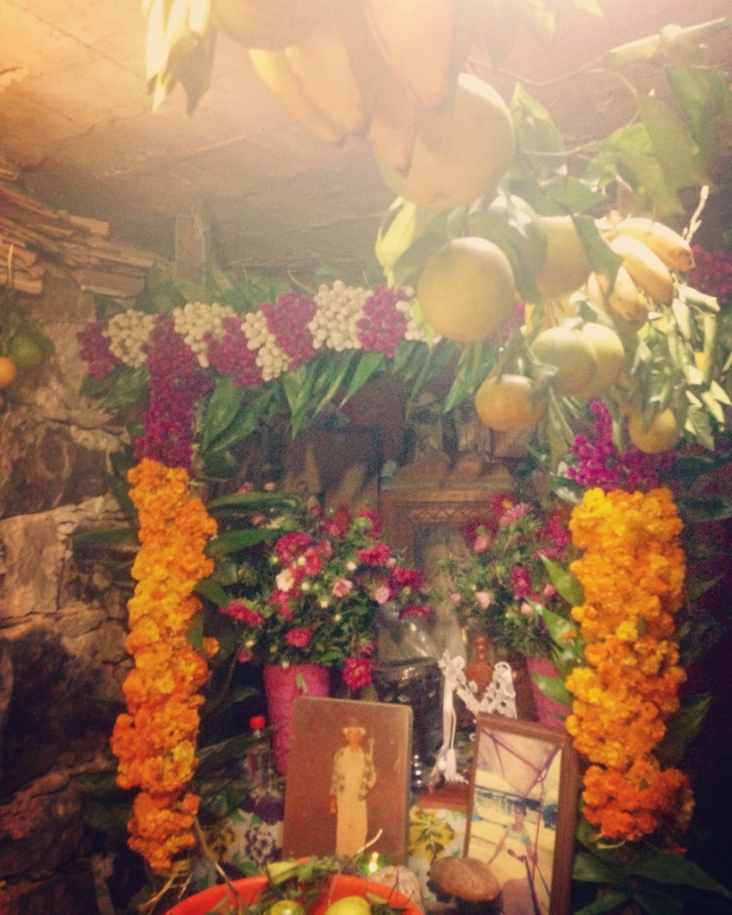 Fruit, cempoaxochitl, photos, candles, and food are placed on the altars in family homes to celebrate and welcome home the spirits of dead ancestors.